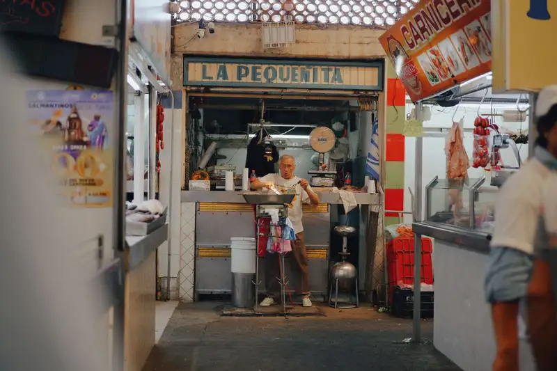 A vendor prepares food at a small market stall called La Pequenita in Mexico.