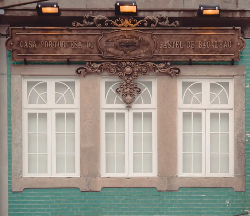 Classic Portuguese architecture with intricate sign and pastel colors in Oporto, Portugal.